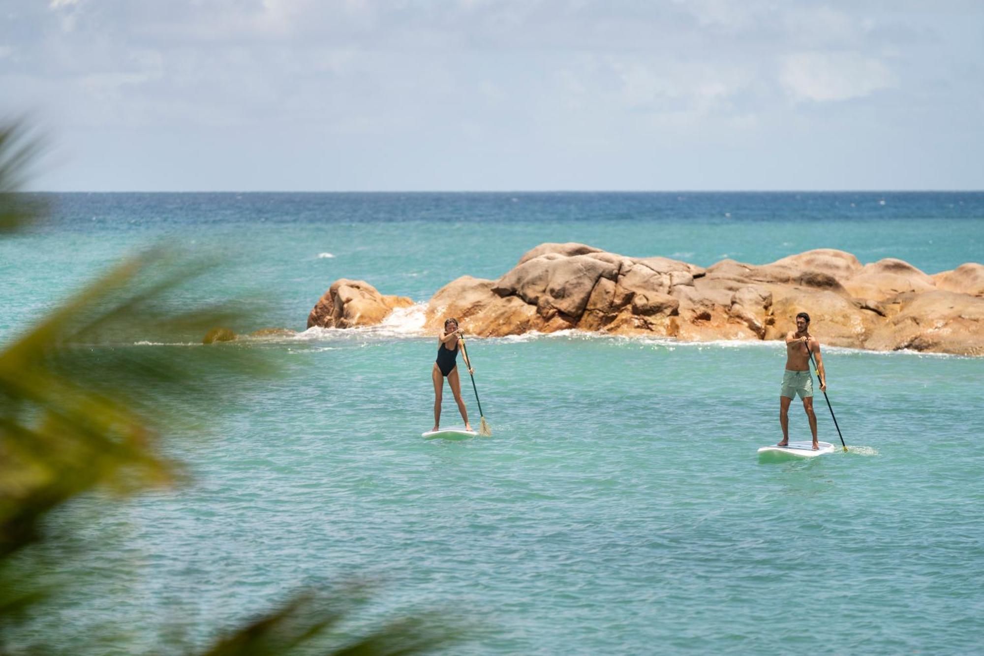 Constance Lemuria Grand Anse  Exterior photo Stand up paddle boarders on the bay